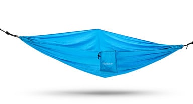 The Under Desk Hammock can be mounted to select UPLIFT Desk frames or between two trees/posts like a traditional hammock