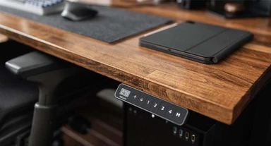 Black Advanced Comfort Angled Keypad on a walnut laminate desk