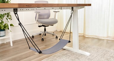 UPLIFT Foot Hammock attached to an UPLIFT Standing Desk with Anchor Plates