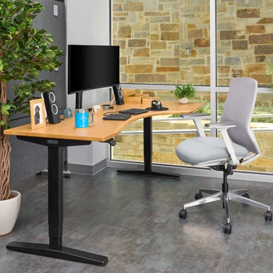 Shown with the V2 frame. Bamboo Curved Corner Standing Desk with right return and an Envoke Chair in Fog