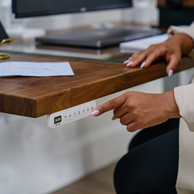 White Advanced Comfort Flush Keypad on an UPLIFT V3 Standing Desk with a Walnut Butcher Block desktop