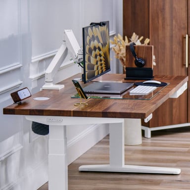  A home office with an UPLIFT 2-leg Standing Desk and Crestview Single Monitor Arm in white