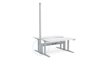 Two UPLIFT V2 Standing Desks connected to a Power & Data Rail with a Power Pole