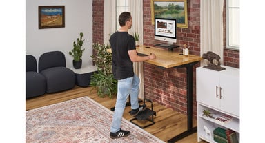 Shift standing positions throughout the day by alternating left and right feet on the footrest