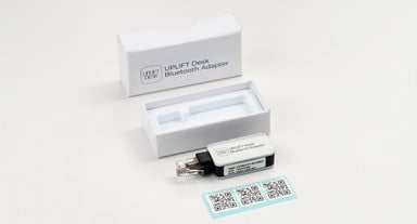 Adapters include QR code stickers as an option to connect to desks via the UPLIFT Desk App