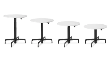 The Height Adjustable Bistro Table boasts an iconic industrial style with the versatility of standing desks, shown at different heights across the 16" travel range.