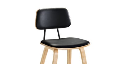 Generously padded seat and backrest cushions are upholstered in faux black leather
