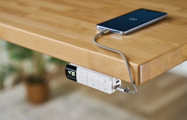 Flush-mounted keypad prevents collisions with objects in front of the desk