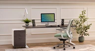 Home office including a white file cabinet with gray laminate drawer fronts