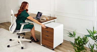 Work comfortably at any height. Featuring a Walnut desktop on a white frame, the Parsons Desk adjusts to support you whether you're sitting or standing
