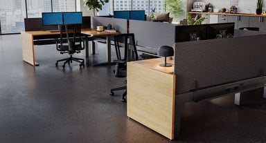 UPLIFT 2-Leg Standing Desks with Fusion Maple desktops and matching Gallery Panels to conceal clutter and personal items beneath desks, keeping them out of sight