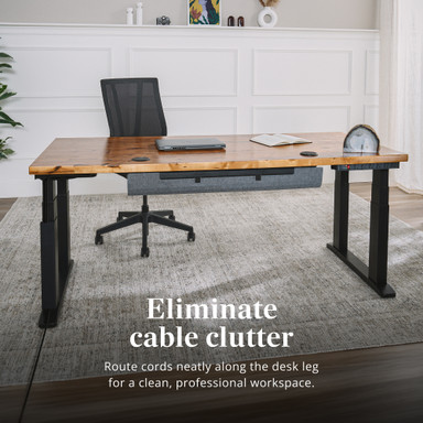Cords disappear into the channel, leaving nothing on display but a clutter-free workspace