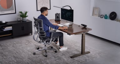 UPLIFT V3 Standing Desk with a Dark Rubberwood desktop and an Intuition Ergonomic Chair