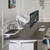 Crestview Dual Monitor Arm in white on an UPLIFT L-Shaped Standing Desk