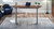 UPLIFT Desk 120-Degree Standing Desk shown with a walnut laminate top on a gray adjustable frame