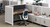 Half-height walls create division and privacy between work spaces while maintaining an open office feel. Shown with MoPac Cabinets, 2-leg standing desk, Crestview dual monitor arm, and Envoke chair in Cobalt blue