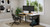 Bamboo E7 Standing Desk Converter in seated position showing the lower keyboard tray positioned lower than the desktop surface

