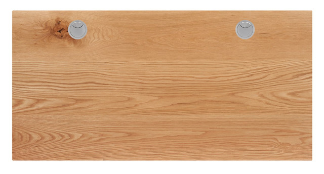 A plain wooden desk top with two circular ports near the top edge.