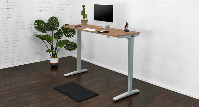 Minimal white desk with built-in cable management and a monitor on top, accessories on the right.