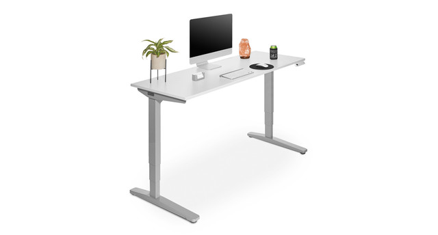 Desk with dark wood tabletop, monitor, lamp, plants, and a mobile pedestal on the left, supported by a metal frame.