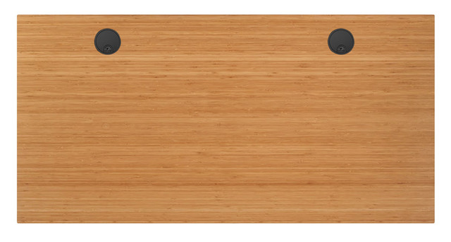 Wooden tabletop with two black circular recesses or caps (presumably floor outlets) installed near the top edge, on a light brown bamboo-like wood.