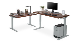 Create an L-shaped workstation with a standing desk and side table