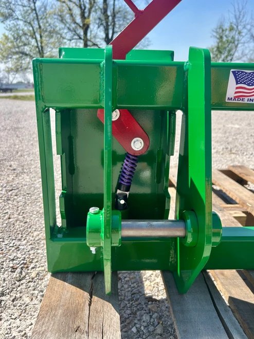 JD 143 Loader to Skid-Steer Attachment Adapter
Two crossbar design keeps the face of thee latch boxes in line and keeps them from twisting and going out of alignment.
Latch box sides are 1/2" thick and are made from grade 50 plate for added strength.
The latching pins are designed so that when the latches are closed the springs are bottomed out so that the pins cannot come unlatched.
Bushing for pins
Grease Zerk in both latching pin tubes
Couples the two different Quick hitches as close as is physically possible for maintaining maximum lifting capacity.
Quick attach adapters are also available for tractor loaders with pin on buckets to convert them to quick attach.

