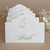 white place card with gold foil monogram