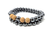 Make a statement with this unique bracelet crafted from polished hematite gemstones and finished with intricate wood accents.