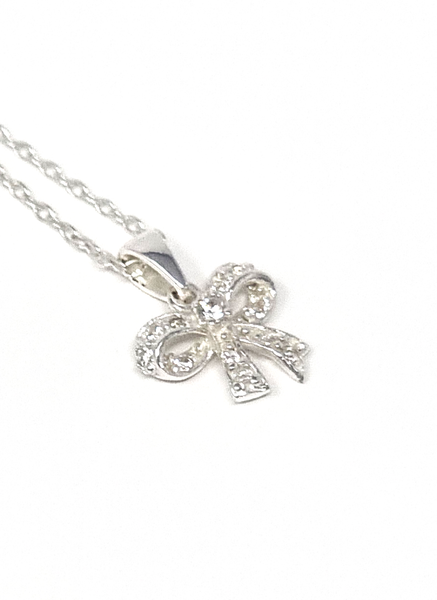 Bow pendant with cubic zirconia, diamond, and sterling silver. Perfect accessory for kids.