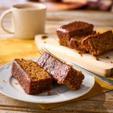Yorkshire Parkin cake served with a hot drink, perfect for a traditional British teatime treat.