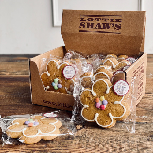ndividually wrapped flower-shaped gingerbread biscuits decorated with icing and colourful chocolate smarties