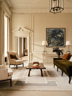 David Rockwell Platinum Metallic rug in a panelled classical drawing room with wingback armchairs and an olive velvet sofa