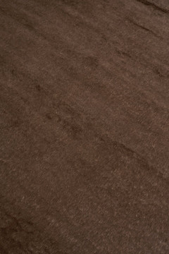 Mohair Shag rug in Carob, angled flatshot showing pile direction