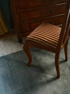 Caliche Silk rug in Aegean, styled vignette with an antique chair leg