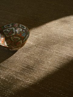 Vara rug in Olive, styled vignette with a cloisonne bowl