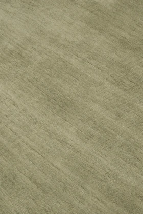 Close-up of Caliche Silk rug in Moss, showing lustrous silk sheen