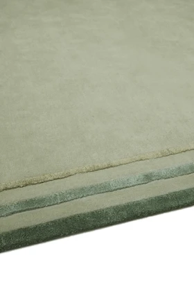 Arc rug in Spruce, studio detail shot showing the raised, layered silk border