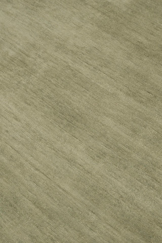 Close-up of Caliche Silk rug in Moss, showing lustrous silk sheen