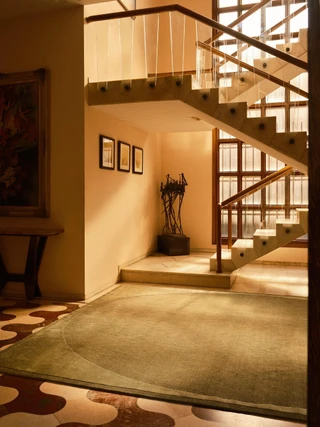 Doma rug in Forest, styled at the base of a staircase landing