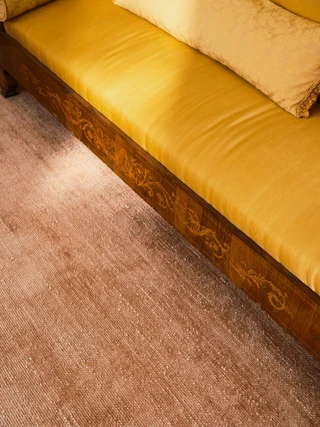 Vara rug in Clay, styled vignette with a silk daybed