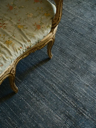 Vara rug in Aegean, styled vignette with an antique settee