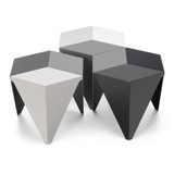 A group of Vitra Prismatic Coffee Tables against a white sweep