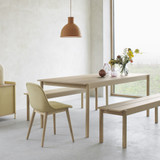 Muuto Fiber Upholstered Wood Base Side Chair at a table