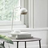 Mater Ray Table Lamp on a table next to a window Mater Ray Table Lamp on a table next to a window