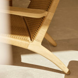 Close up of a Carl Hansen CH25 Lounge Chair in Oiled Oak