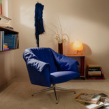 Vitra Bascule Low Back Lounge Chair by a book shelf