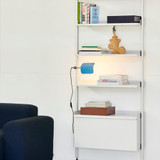 A Sky Blue HAY Apex Clip Lamp attached to some white shelves