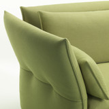 A close up of a Vitra Maripose 2 1/2-Seater Sofa in Green against a white background