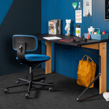 Vitra Rookie Office Chair in blue next to a desk
